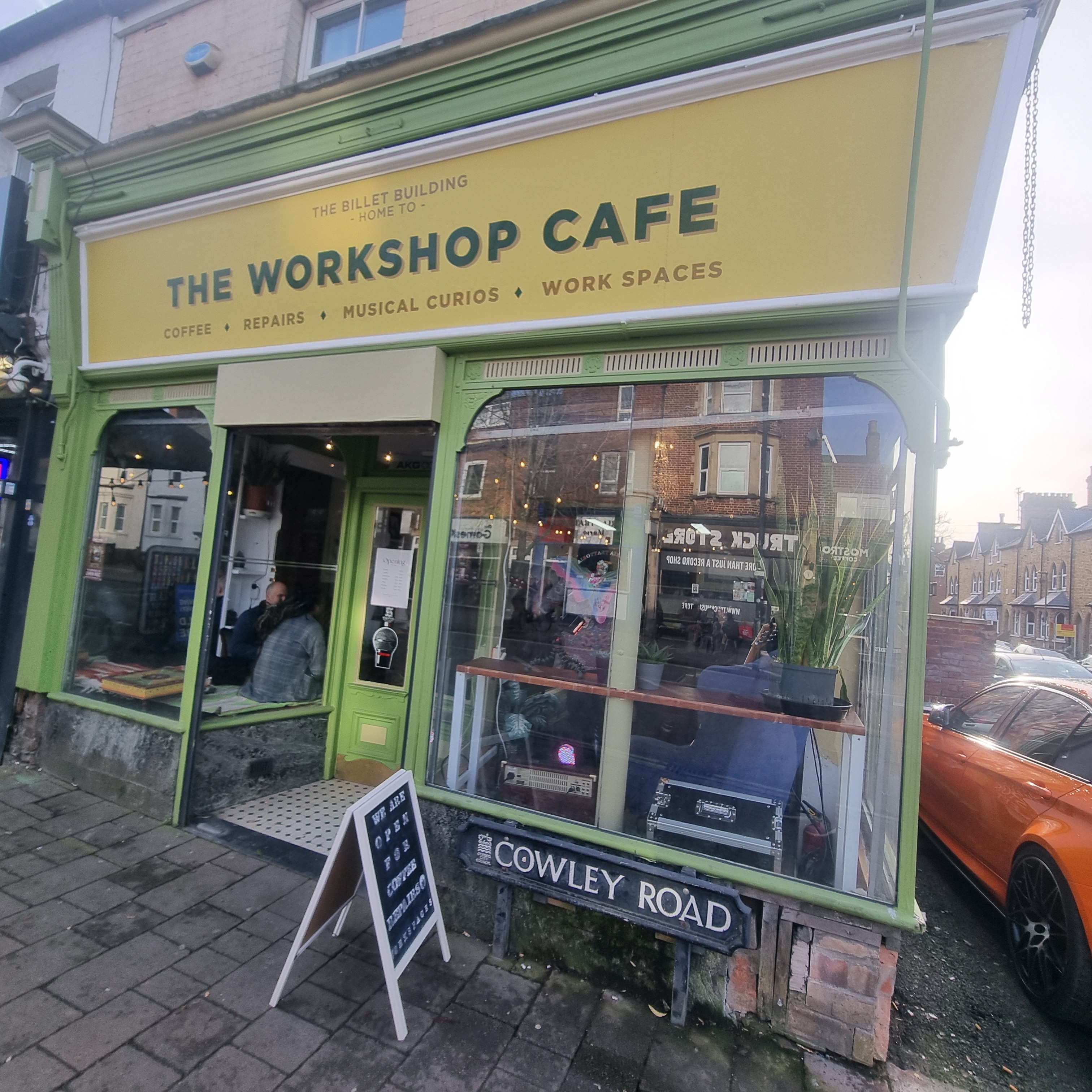 Workshop Café storefront — green heritage shopfront on Cowley Road